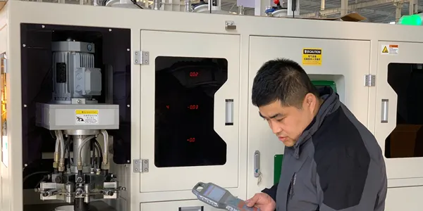 An operator is working beside the PU dispensing machine for air filters.