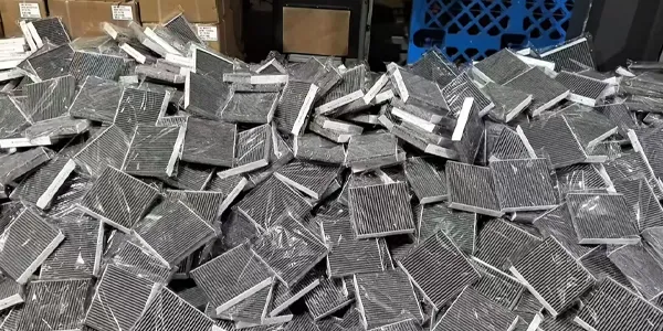 Many cabin air filters stacked together.