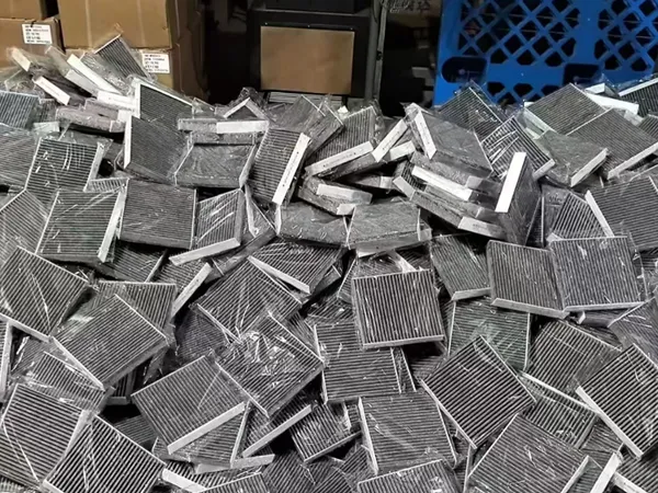 Many cabin air filters stacked together.