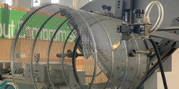 An automated spiral rolling machine producing heavy-duty truck air filter outer mesh.