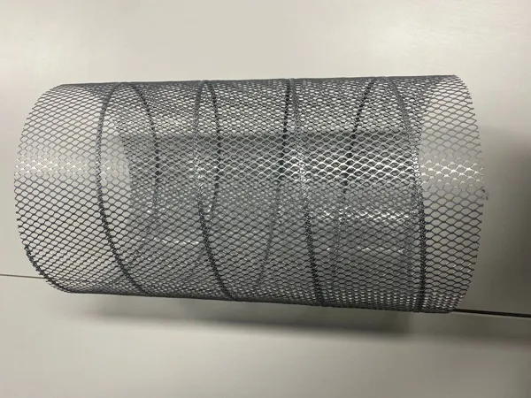 Finished heavy-duty truck air filter outer mesh placed on the ground.