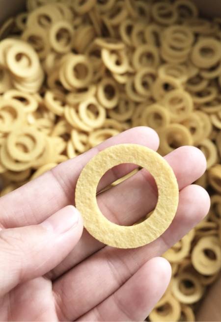 A hand is holding a filter material of eco filter.