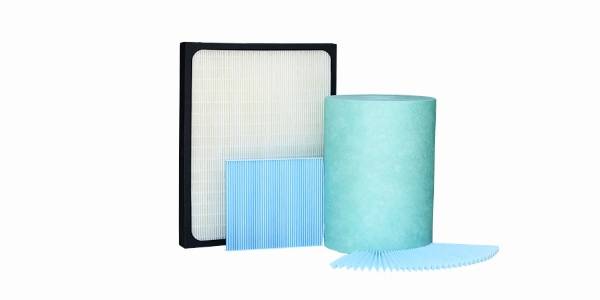 Several industrial non-woven filter cloth on white background.