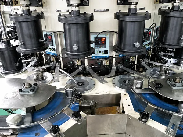 Automated assembly and testing process in an oil filter production line.