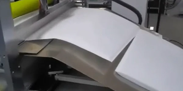 This is an automatic box-folding machine processing a white sheet for package production.