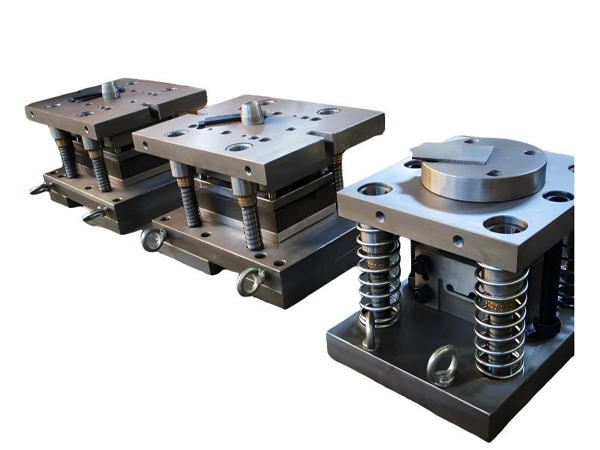 Three stamping compound molds on a white background